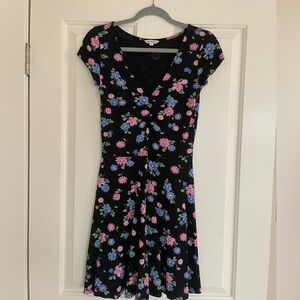 Black mini dress with flowers print.